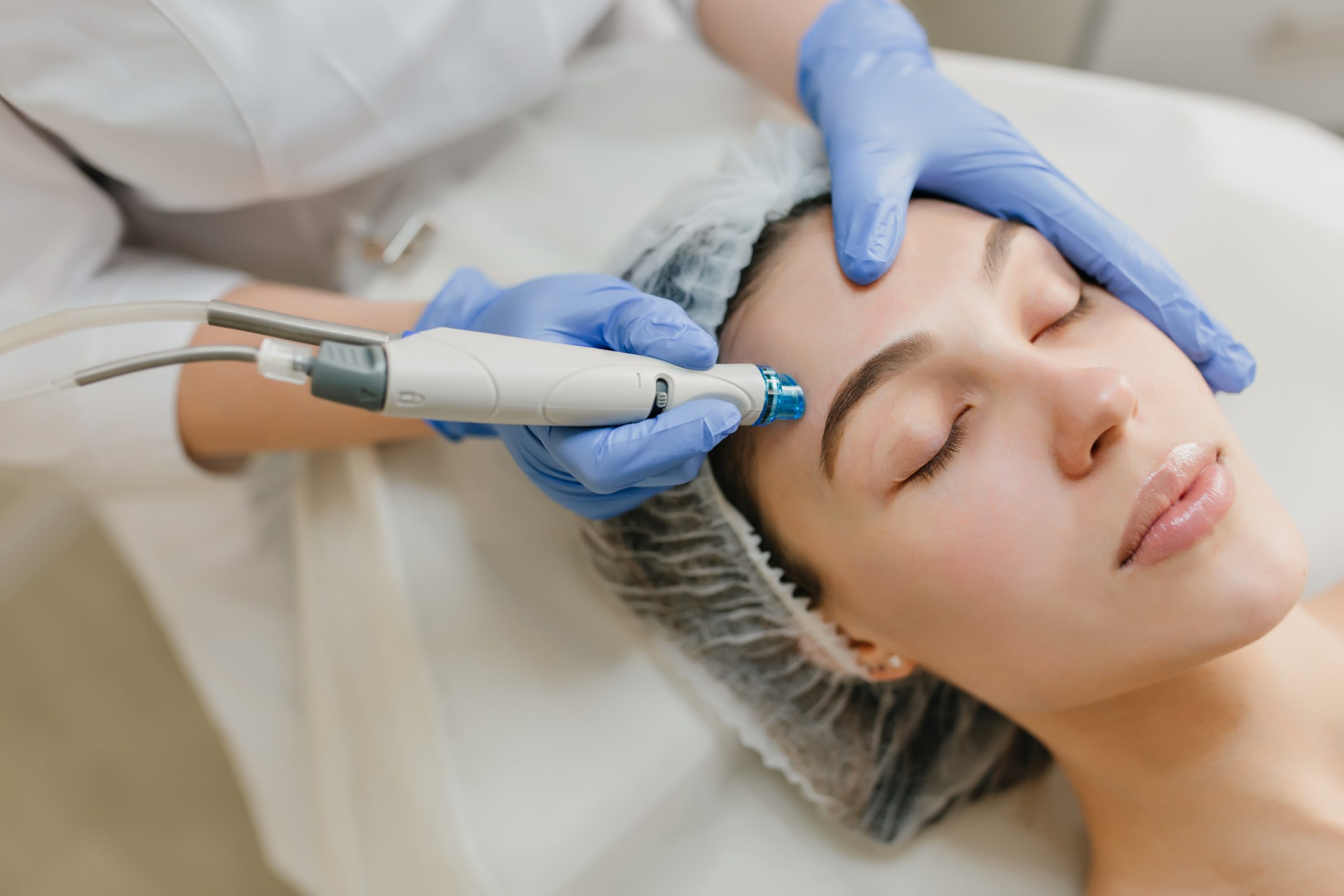 Closeup portrait of beautiful woman during cosmetology therapy in beauty salon. Professional dermatology procedures, lifting, rejuvenation, modern devices, healthcare.